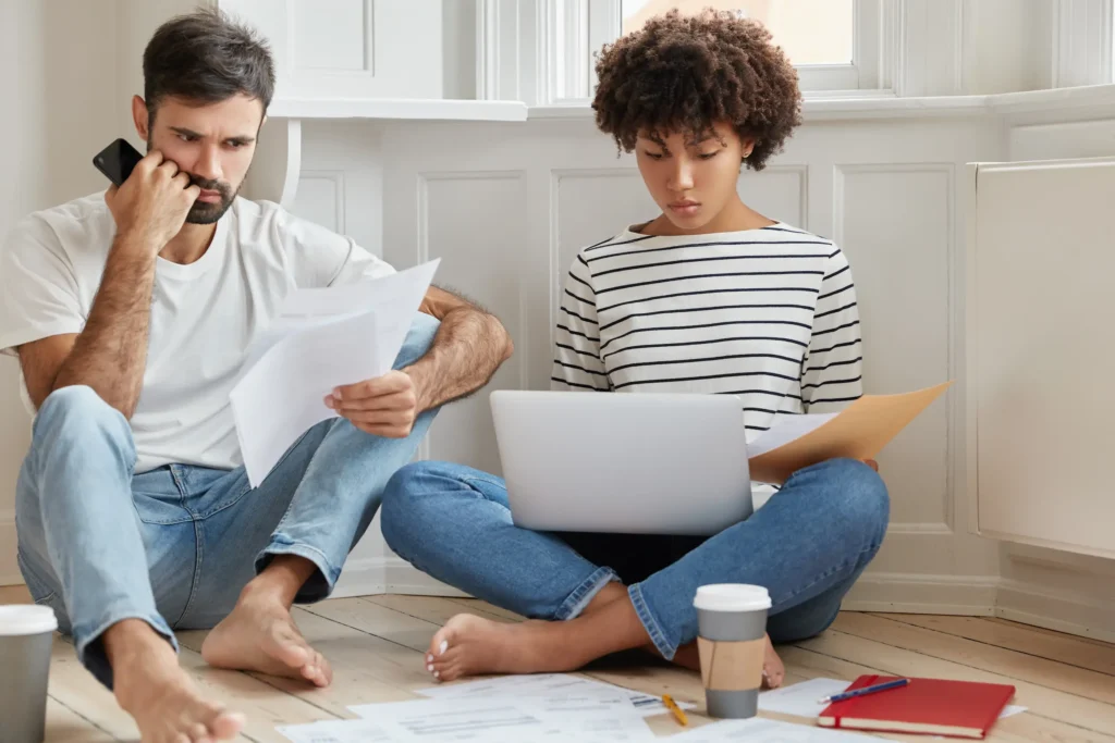 photo-two-mixed-race-coworkers-read-documentation-concentrated-solving-problem-with-planning