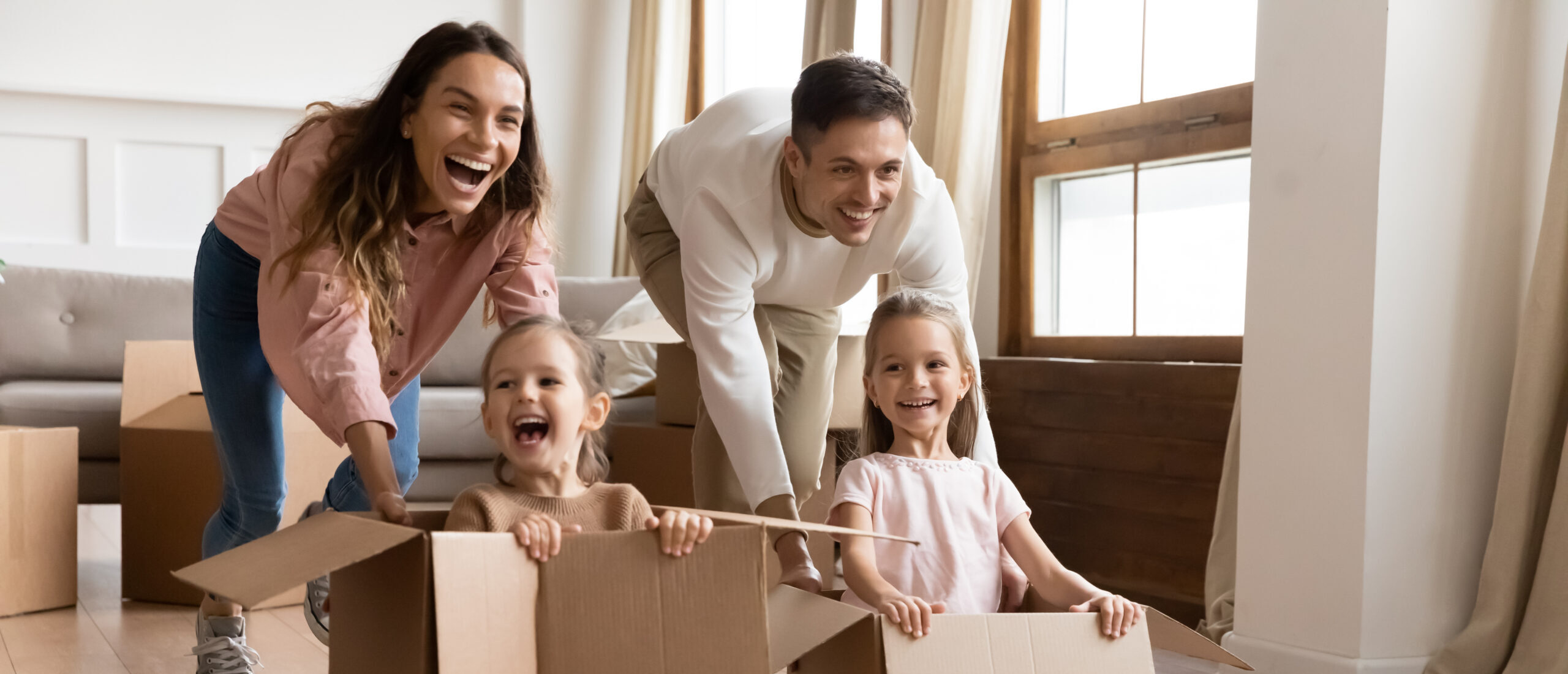 Parents playing with their kids while getting ready to move out.
